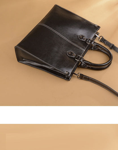 Black Elegant Leather Handbag - StylishTote with Adjustable Strap, Spacious and Durable